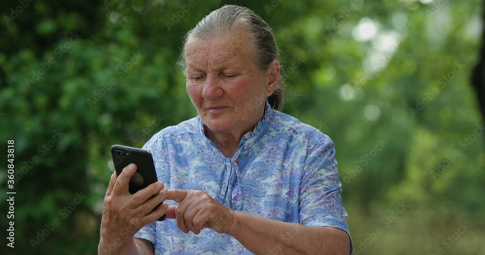 Older grey haired grandma enjoy using mobile app, senior lady texting typing message hold smart phone look at cellphone screen browsing social media at home, old people tech users concept Older grey haired grandma enjoy using mobile app, senior lady texting typing message hold smart phone look at cellphone screen browsing social media at home, old people tech users concept
