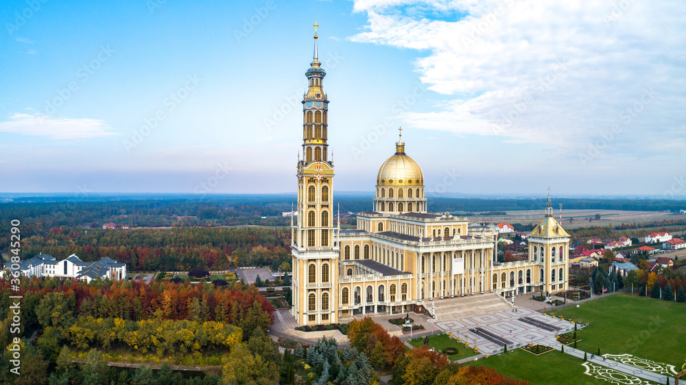 Sanctuary and Basilica of Our Lady of Licheń in village Lichen. The biggest church in Poland, one of the largest in the World. Famous Catholic pilgrimage site. Aerial panorama in fall. Sunset light