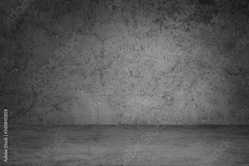 Empty space of Studio dark room black concrete grunge wall with concrete floor.