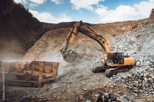 Wallpaper Mural Industrial heavy duty excavator moving gravel on highway construction site. Multiple industrial machinery on construction site Torontodigital.ca