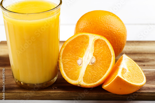 glass of juice and oranges