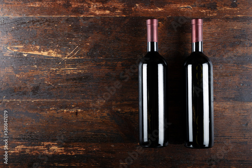 two bottles of wine on wooden background