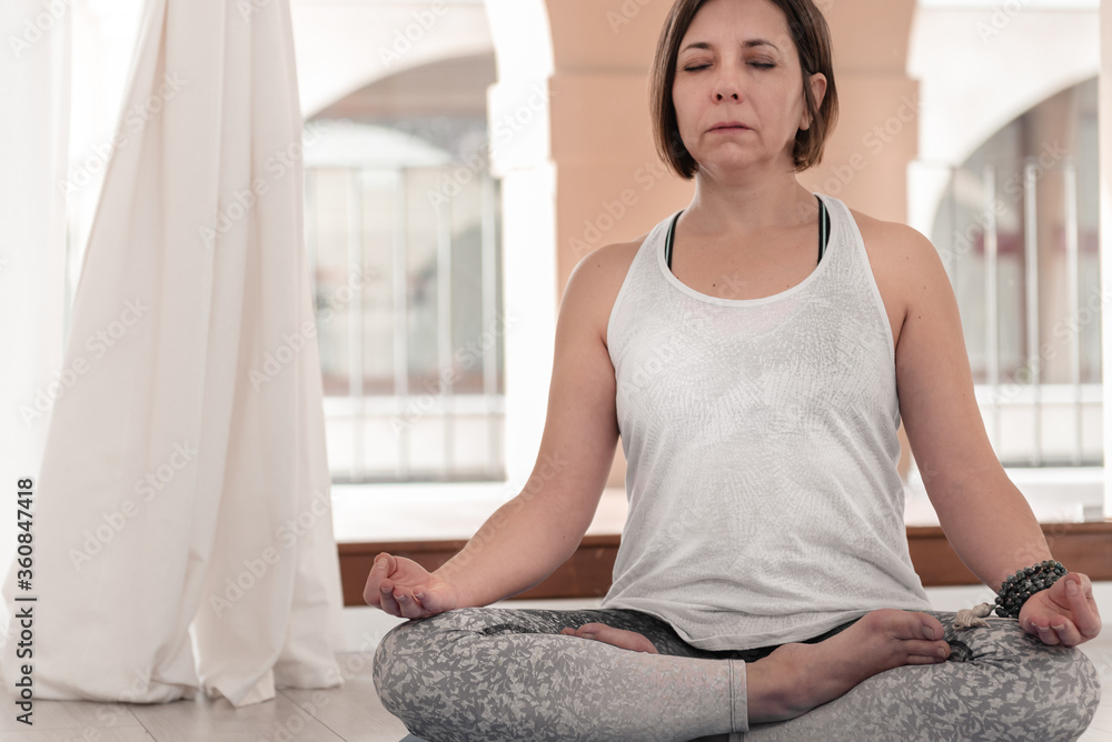 Yoga teacher sitting in the lotus position. Woman practicing Yoga. How to Keep Your Arms for a Kriya or Meditation. Yoga teacher sitting in the lotus position. Woman practicing Yoga. How to Keep Your Arms for a Kriya or Meditation.
