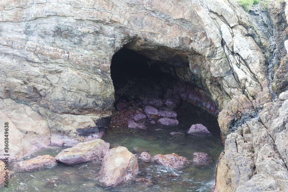 sea cave and rocks on coastline of beach