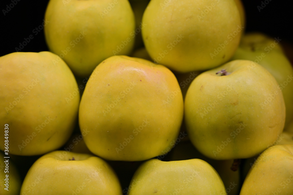 A large photo of fruit apples on a tray in a store, ready to sell fruit