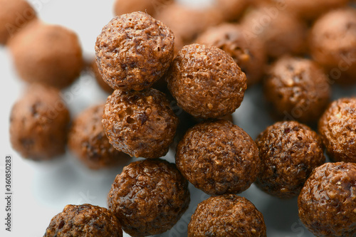 Breakfast cereal balls with chocolate on a white background