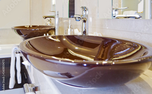 Elegant and modern design bathroom with double vanity and brown porcelain sinks  in clean style in suite on luxury cruiseship or cruise ship liner photo