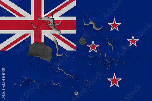 New Zealand flag close up old, damaged and dirty on wall peeling off paint to see inside surface. Vintage National Concept.