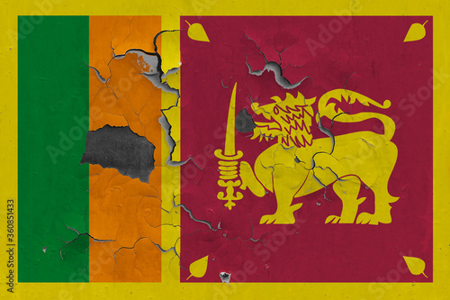 Sri Lanka flag close up old, damaged and dirty on wall peeling off paint to see inside surface. Vintage National Concept.