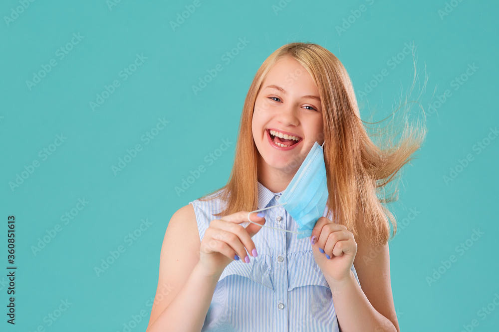 The girl laughs and takes off the mask and smiles, good mood. The concept of quarantine of coronaviruses, the theme of health and medicine. Medical virus poster design. Free space for text. The girl laughs and takes off the mask and smiles, good mood. The concept of quarantine of coronaviruses, the theme of health and medicine. Medical virus poster design. Free space for text.