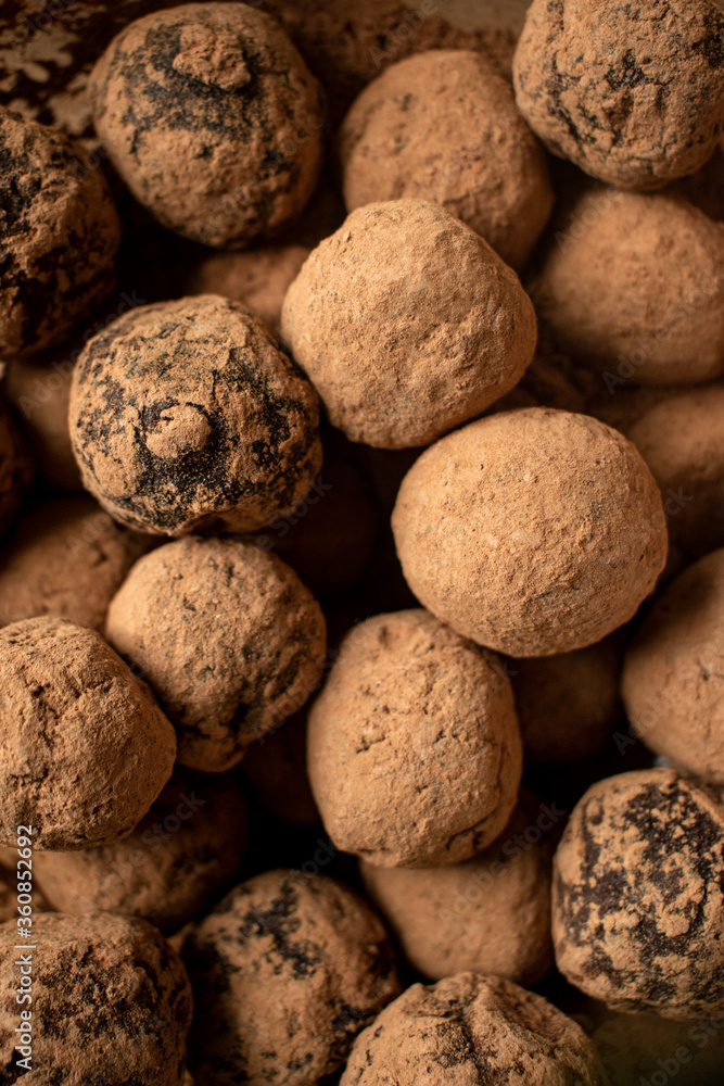 Pile of sweet truffle candies in cocoa powder close-up. Pile of sweet truffle candies in cocoa powder close-up.