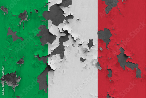 Italy flag close up painted, damaged and dirty on wall peeling off paint to see concrete surface. Vintage National Concept.