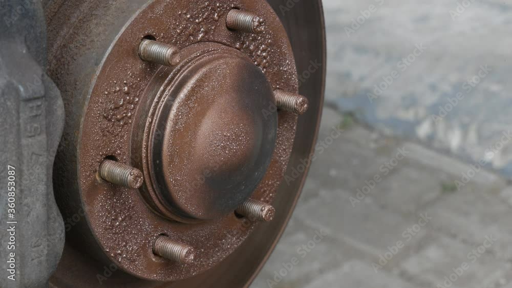 Video Stock auto mechanic applies copper grease to automobile wheel