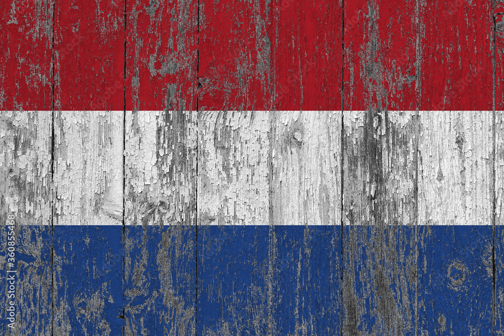 Netherlands flag on grunge scratched wooden surface. National vintage background. Old wooden table scratched flag surface.