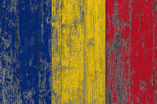 Romania flag on grunge scratched wooden surface. National vintage background. Old wooden table scratched flag surface. © sezerozger