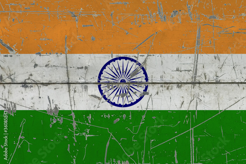 India flag painted on cracked dirty surface. National pattern on vintage style surface. Scratched and weathered concept.