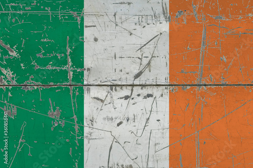 Ireland flag painted on cracked dirty surface. National pattern on vintage style surface. Scratched and weathered concept. © sezerozger
