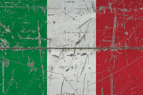 Italy flag painted on cracked dirty surface. National pattern on vintage style surface. Scratched and weathered concept. © sezerozger