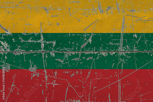 Lithuania flag painted on cracked dirty surface. National pattern on vintage style surface. Scratched and weathered concept. © sezerozger