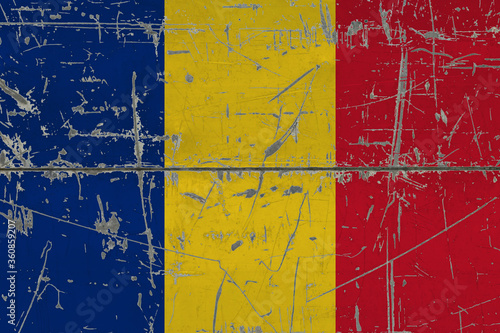 Romania flag painted on cracked dirty surface. National pattern on vintage style surface. Scratched and weathered concept. © sezerozger