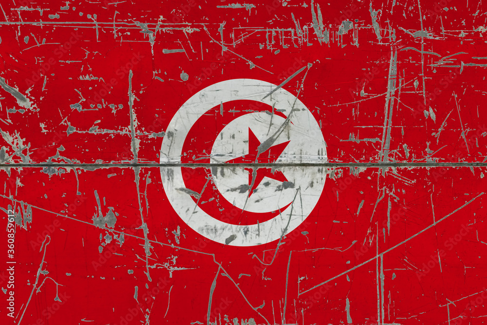 Obraz premium Tunisia flag painted on cracked dirty surface. National pattern on vintage style surface. Scratched and weathered concept.