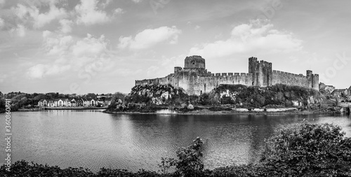 Landscape with the ruins of Pembroke Castle on the shores of river Pembroke, the original family seat of the Earldom of Pembroke in Pembrokeshire, Wales, UK