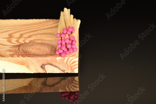 Matches made of wood, close-up, on a black background.
