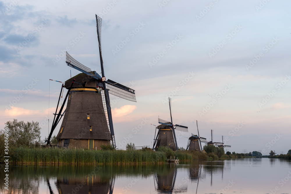 windmills in the netherlands along a canal
