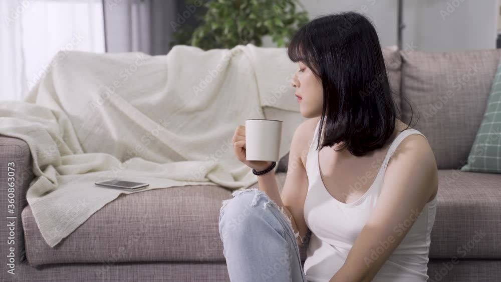 asian girl relaxing with tea in parlor noticed incoming call and pick it up. lovely chinese female answering phone from a good friend with cheerful mood. asian girl relaxing with tea in parlor noticed incoming call and pick it up. lovely chinese female answering phone from a good friend with cheerful mood.