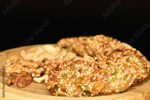 Several fresh fragrant tasty nutty cookies on a black background.