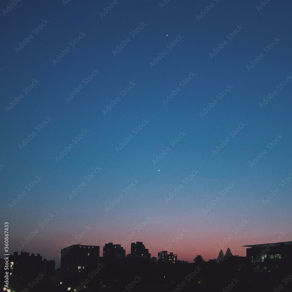 crescent moon and sunset in the city crescent moon and sunset in the city