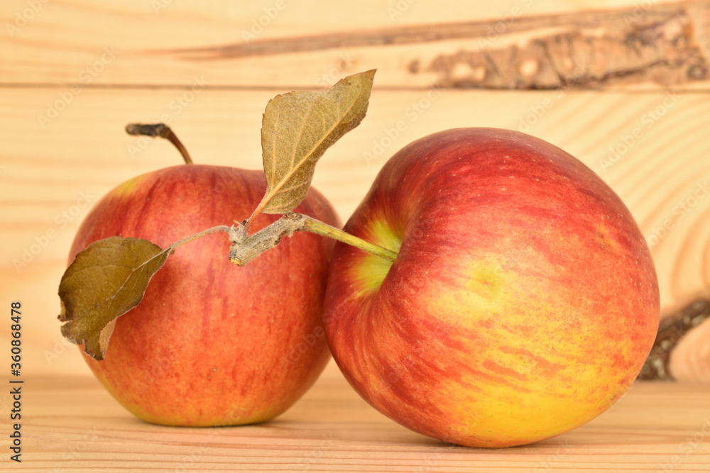 Ripe red apples, close-up, on a background of natural wood. Ripe red apples, close-up, on a background of natural wood.