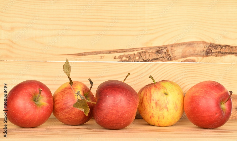 Ripe red apples, close-up, on a background of natural wood. Ripe red apples, close-up, on a background of natural wood.