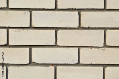 White brick wall. Texture. Background. The seams between the bricks are made of cement. It's a good one. Building. Copy space for text.