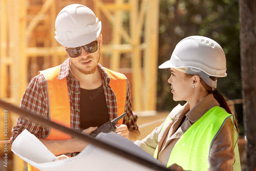 Fototapeta premium Two young architects or engineers discussing a project plan