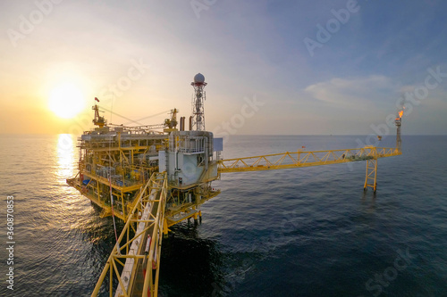 Offshore oil and gas or rig platform with beautiful sky in the evening time for oil and gas business concept