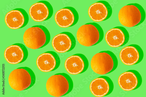 sorted cut orange on green background. Image of fresh oranges for the summer. refreshing background.