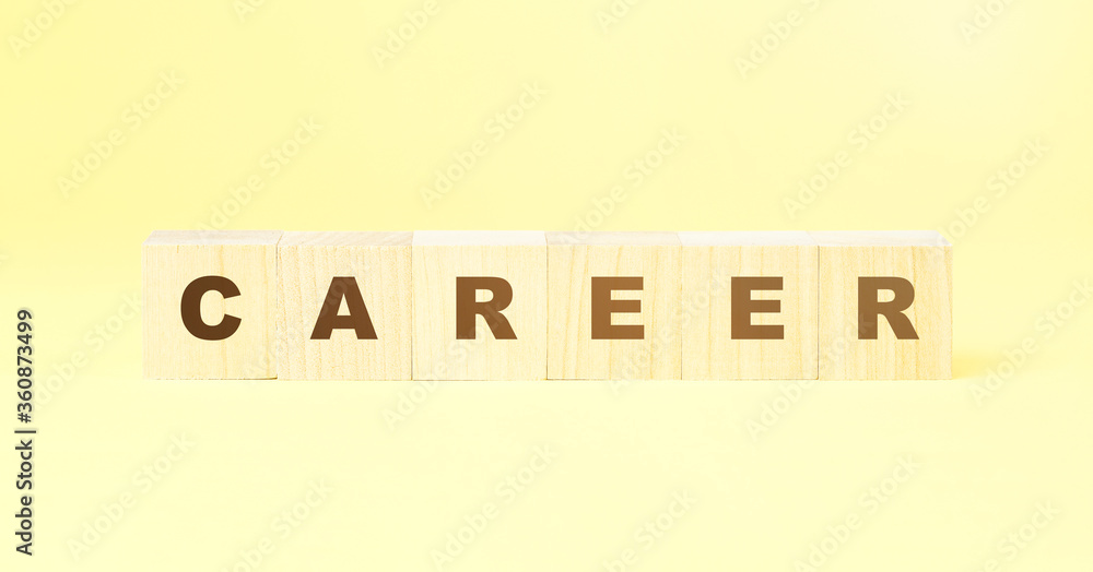 word career made with wooden cubes on yellow background word career made with wooden cubes on yellow background