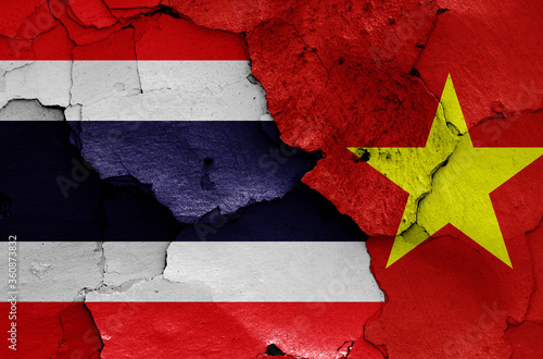 flags of Thailand and Vietnam painted on cracked wall