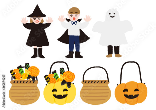 ハロウィンの仮装をした子供たちとキャンディーの入ったカゴ