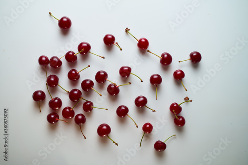 Group of cherry on a white background with shadows. Close-up. Top view.
