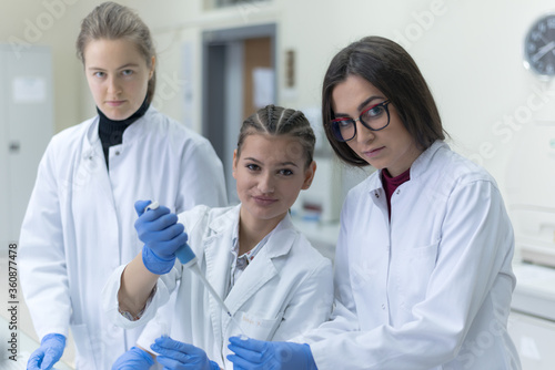 Group of  Laboratory scientists working at lab with test tubes  test or research in clinical laboratory.Science  chemistry  biology  medicine and people concept.