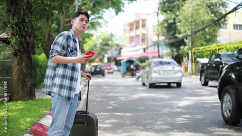 Asian man waiting for Uber taxi