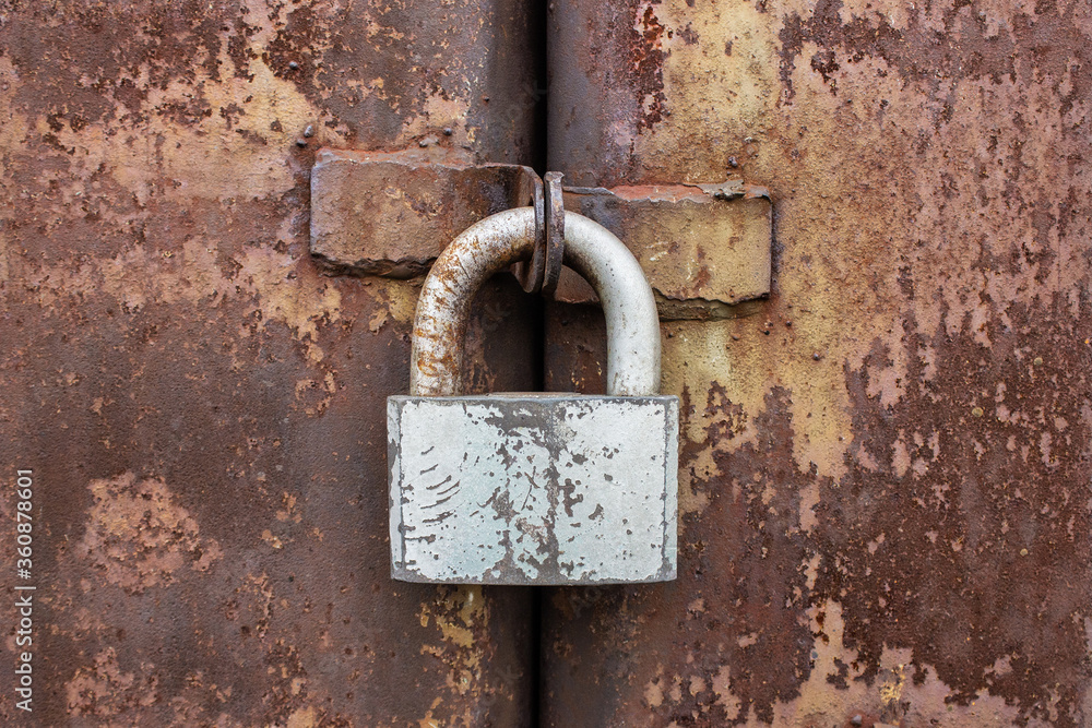 old lock on an iron rusty door. Close up macro old lock on an iron rusty door. Close up macro