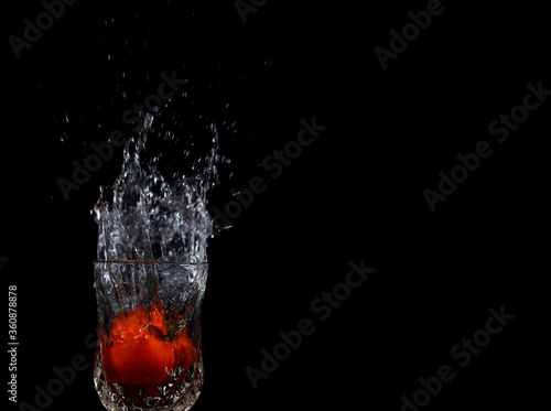 vegetable splashing into clear water on Black background, splash healthy food diet freshness concept.Water Splash.