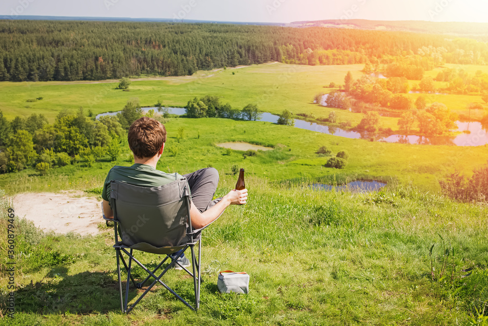 Man resting in a camping chair with beautiful view