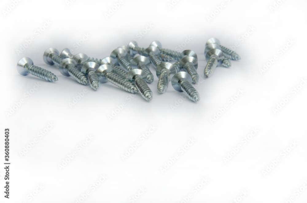 Silver screws on a white background close up
Silver screws on a white background close up