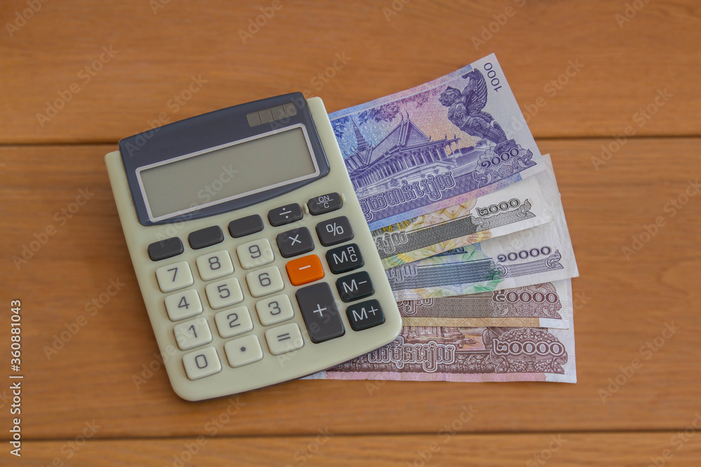 Cambodia banknotes with calculator , concept of growth and financial business investment Cambodia banknotes with calculator , concept of growth and financial business investment