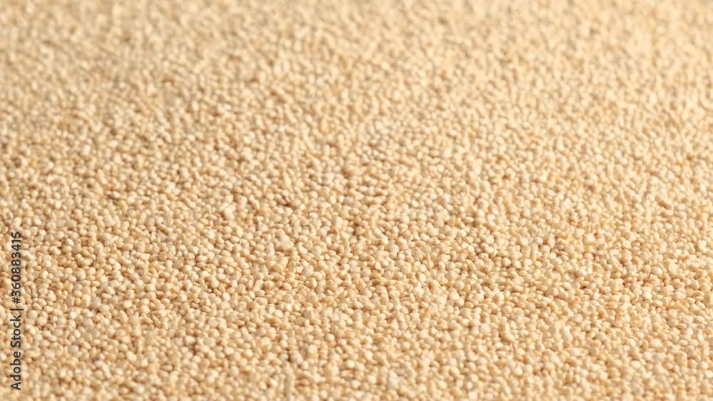 White raw quinoa rotating, South American grain. Healthy and gluten free food concept background.