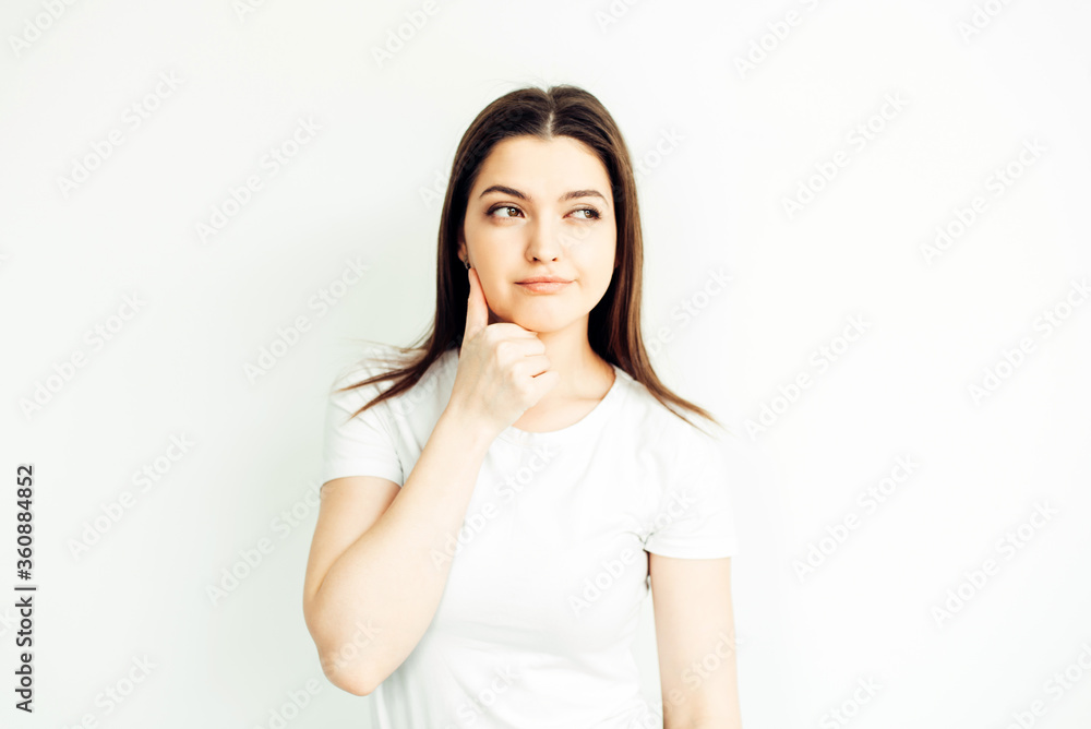 Young girl 25 years old, emotion - doubt. White background Young girl 25 years old, emotion - doubt. White background